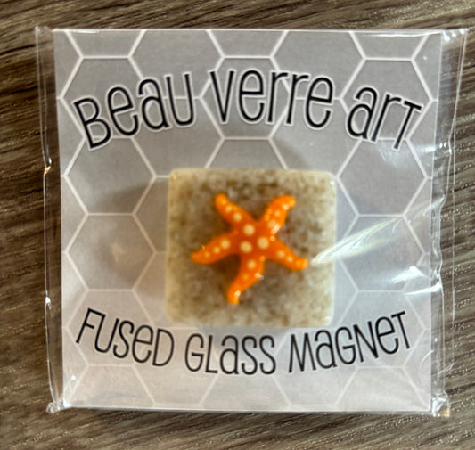 Orange starfish on sand Needleminder